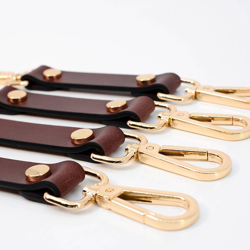 arany színű karabiner bőr szíjjakkal